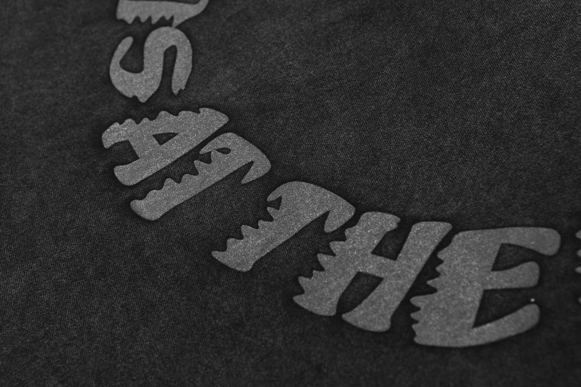 Justin bieber swag merch close-up black fabric with glittery text design.