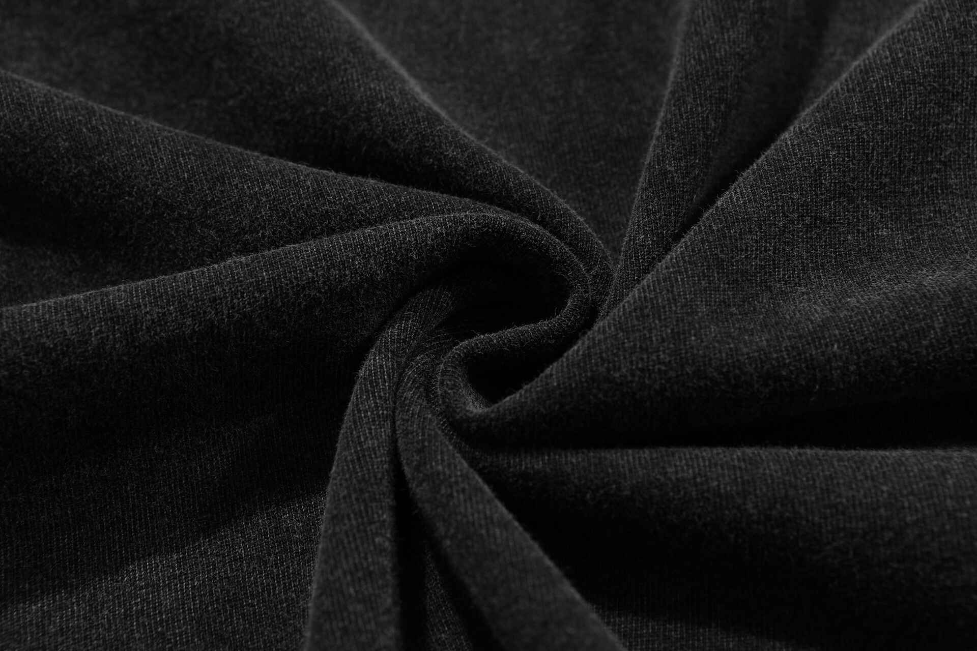 Black fabric close-up with a twisted appearance.