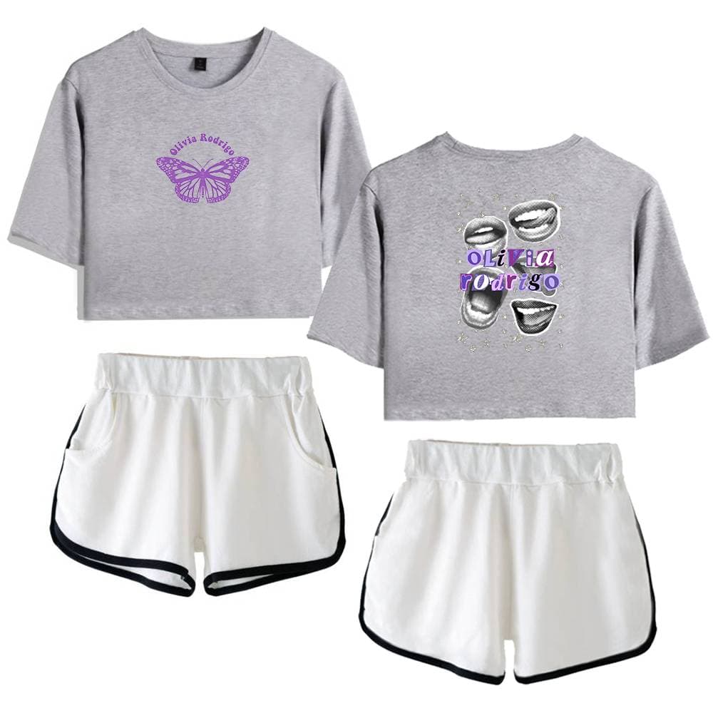 Gray oversized graphic T-shirt with butterfly design and "Olivia Rodrigo" text, paired with white athletic shorts with black trim, inspired by Justin Bieber swag merchandise.