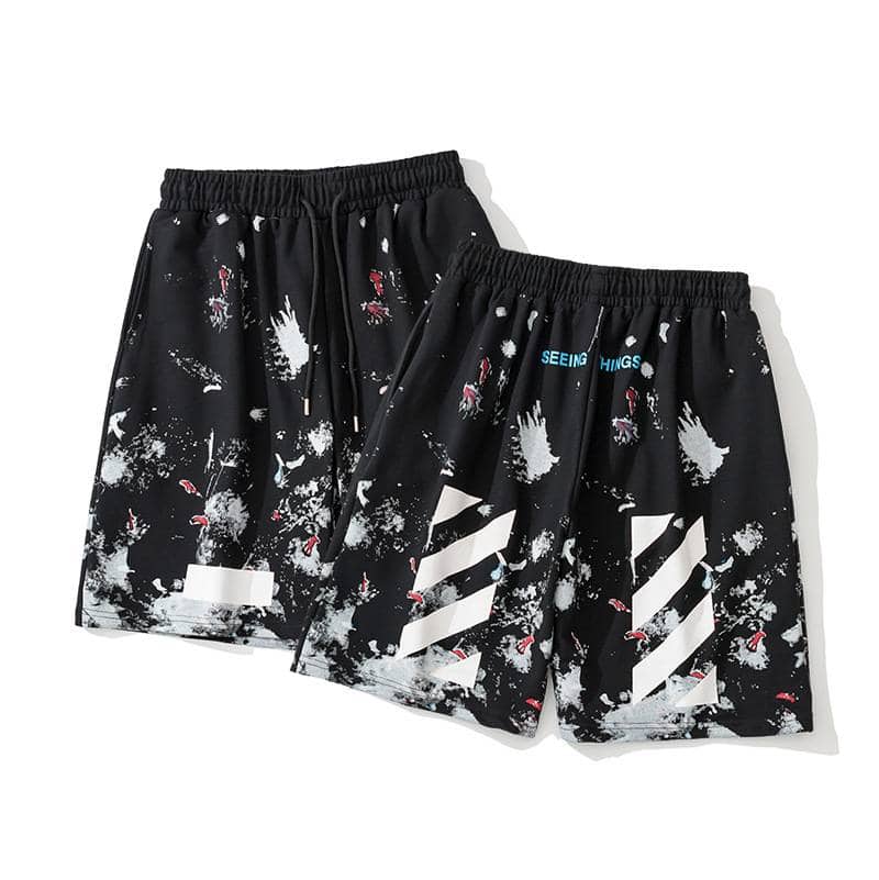 Black swag shorts with abstract paint splatter and stripe design, featuring a sporty and trendy look inspired by Justin Bieber's merchandise style.