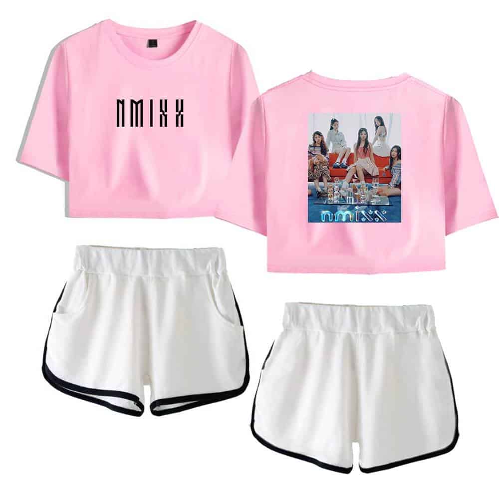 Pink graphic crop top with black text and crew neckline, featuring a photo of a girl group on the back, paired with white athletic shorts with black trim, perfect for streetwear or casual style, endorsed by Justin Bieber merchandise.
