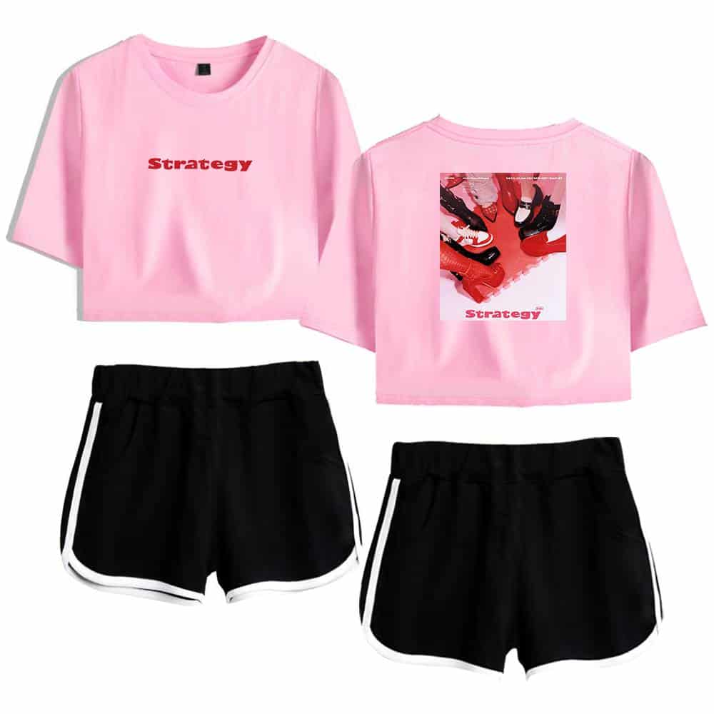 Pink crop top with "Strategy" text, featuring a graphic design on the back, paired with black athletic shorts with white trim. Trendy Justin Bieber swag merch for streetwear fans.