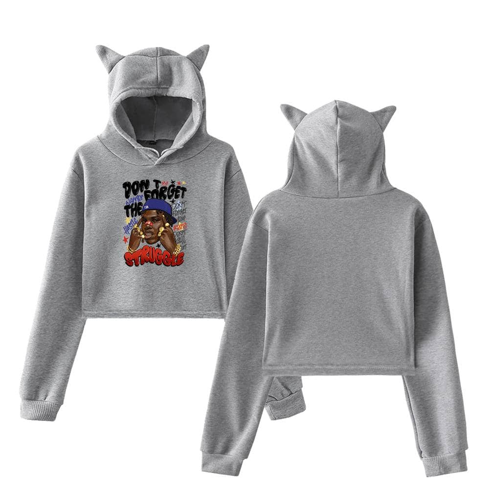 Bright gray hoodie and sweatpants set featuring playful cat ears on the hoodie and a colorful graphic design with the text "Don't Forget The Struggle" and an illustration of a person wearing a blue cap, perfect for Justin Bieber swag merch fans.