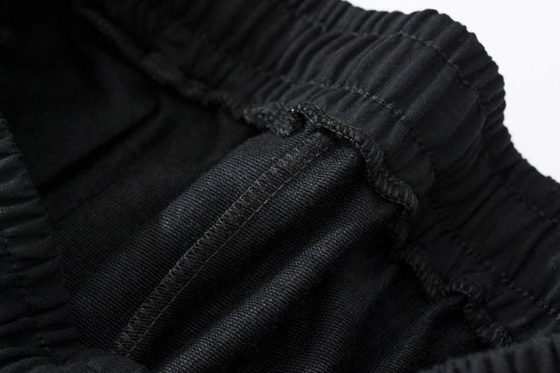 Black Justin Bieber swag merchandise hoodie waistband close-up image.