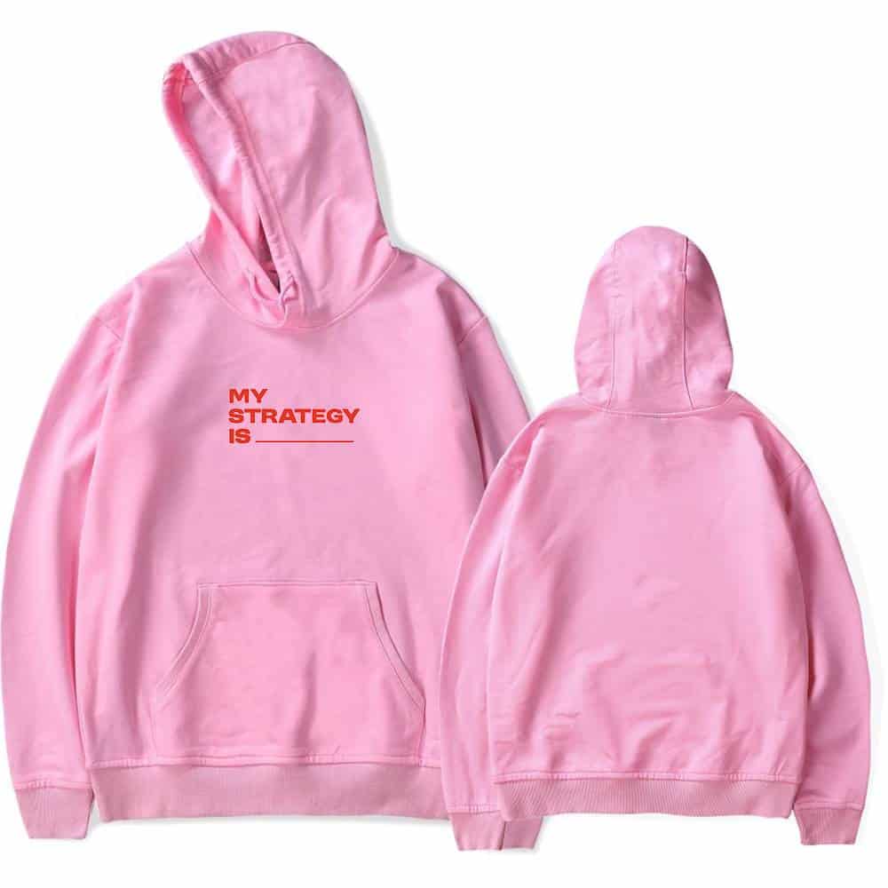 Pink hoodie featuring bold text "MY STRATEGY IS" in red, with a front kangaroo pocket and a relaxed fit. Perfect for Justin Bieber fans who love swag and stylish streetwear.
