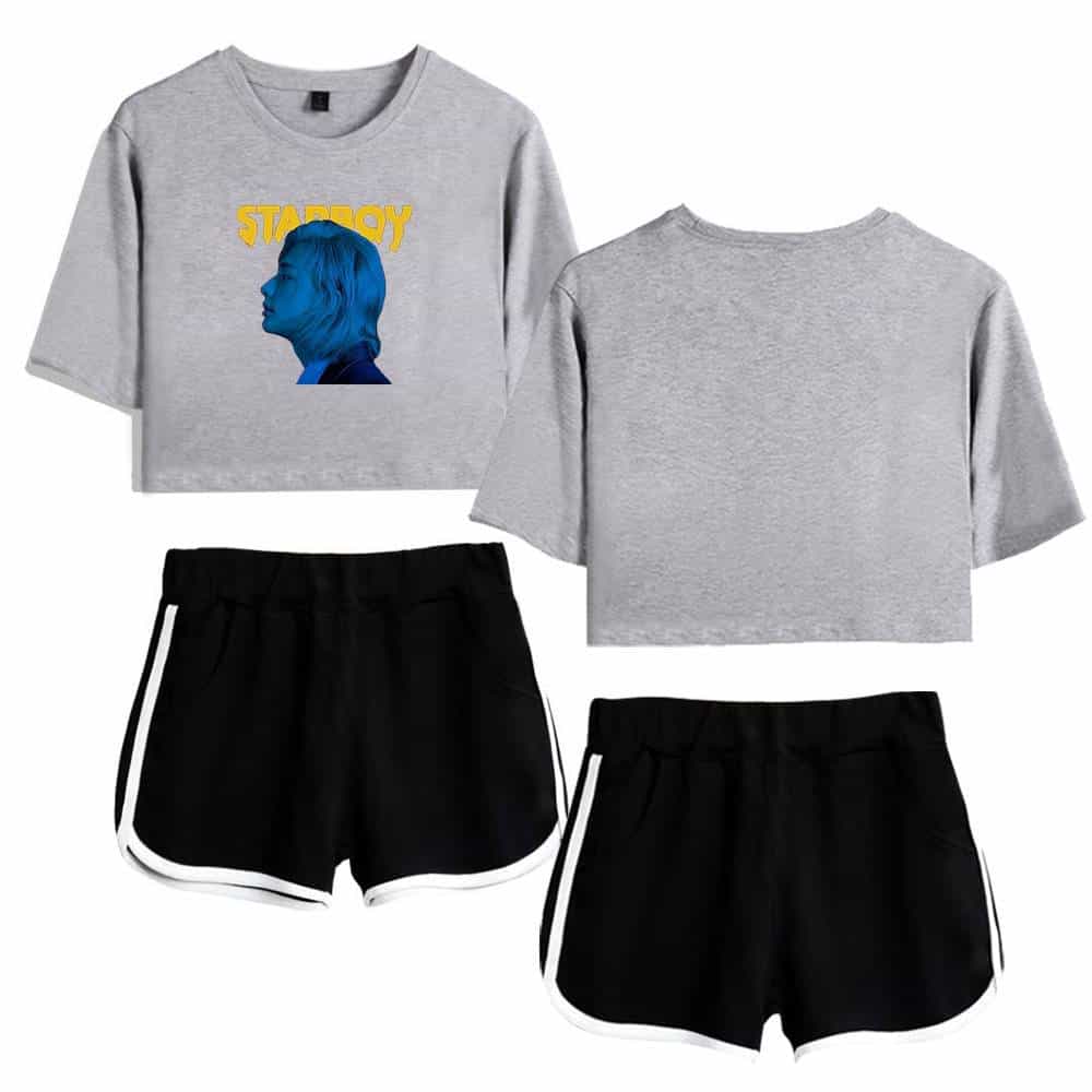 Justin Bieber swag merch featuring a trendy gray cropped t-shirt with a blue silhouette of a woman and playful yellow text, paired with stylish black athletic shorts with white trim.