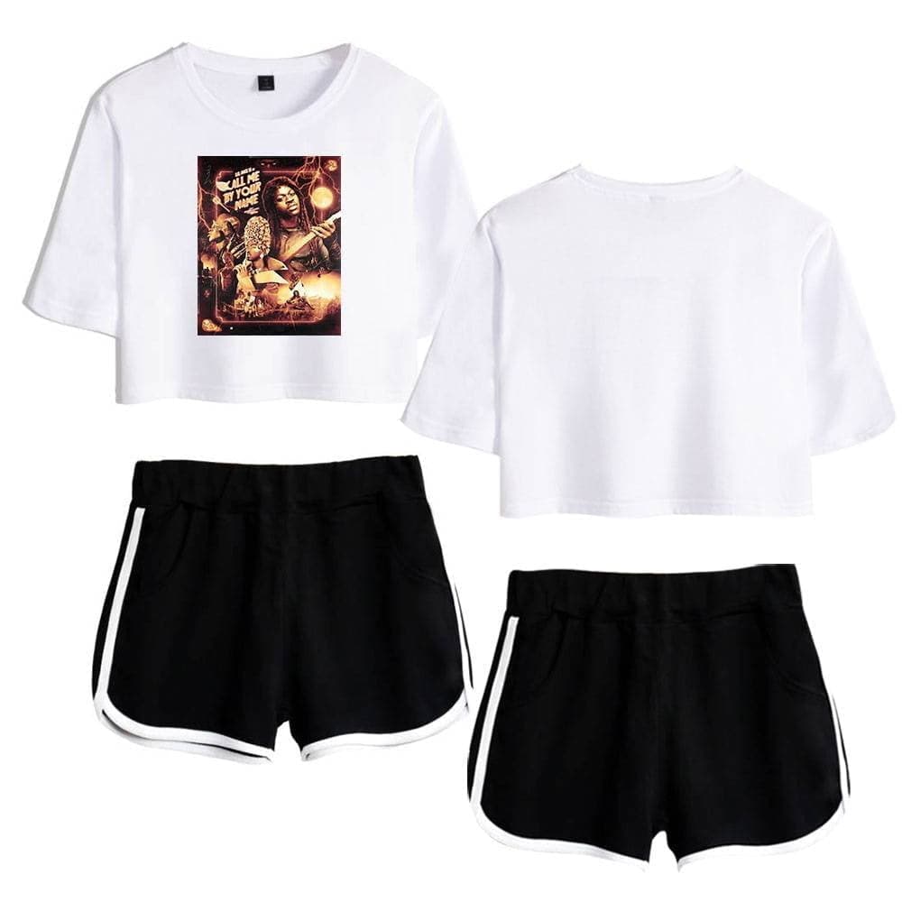Justin Bieber swag merchandise featuring a stylish white cropped T-shirt with a vibrant graphic print, paired with sporty black shorts with white trim, perfect for fans looking to showcase their Bieber-inspired fashion sense.