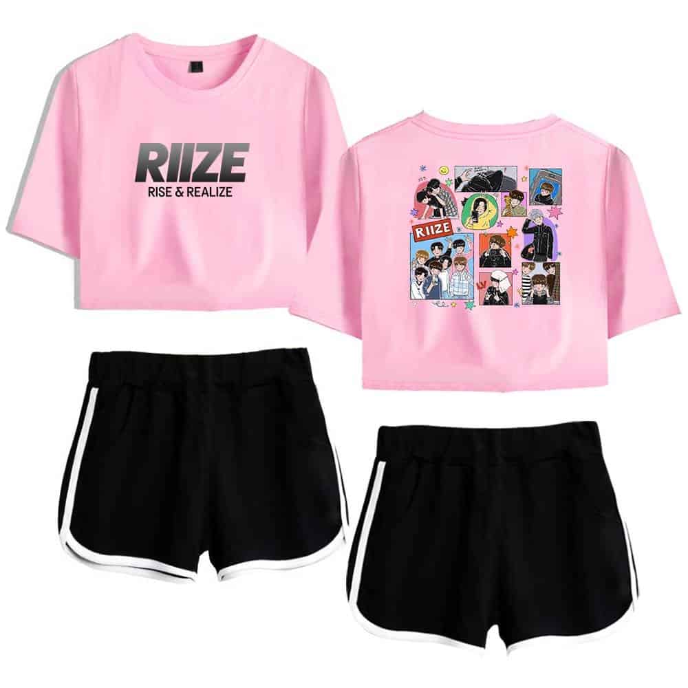 RUIZE pink crop top with "RISE & REALIZE" slogan, featuring colorful comic-style illustrated artwork on the back, paired with black sporty shorts with white trim.