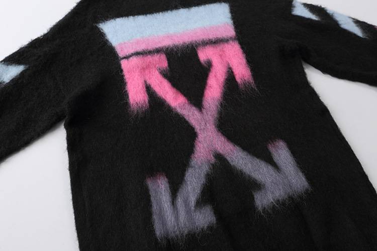 Bright pink, purple, and light blue "VXN" logo on a black fuzzy sweatshirt, inspired by Justin Bieber's swag merchandise line, featuring bold and trendy design elements.