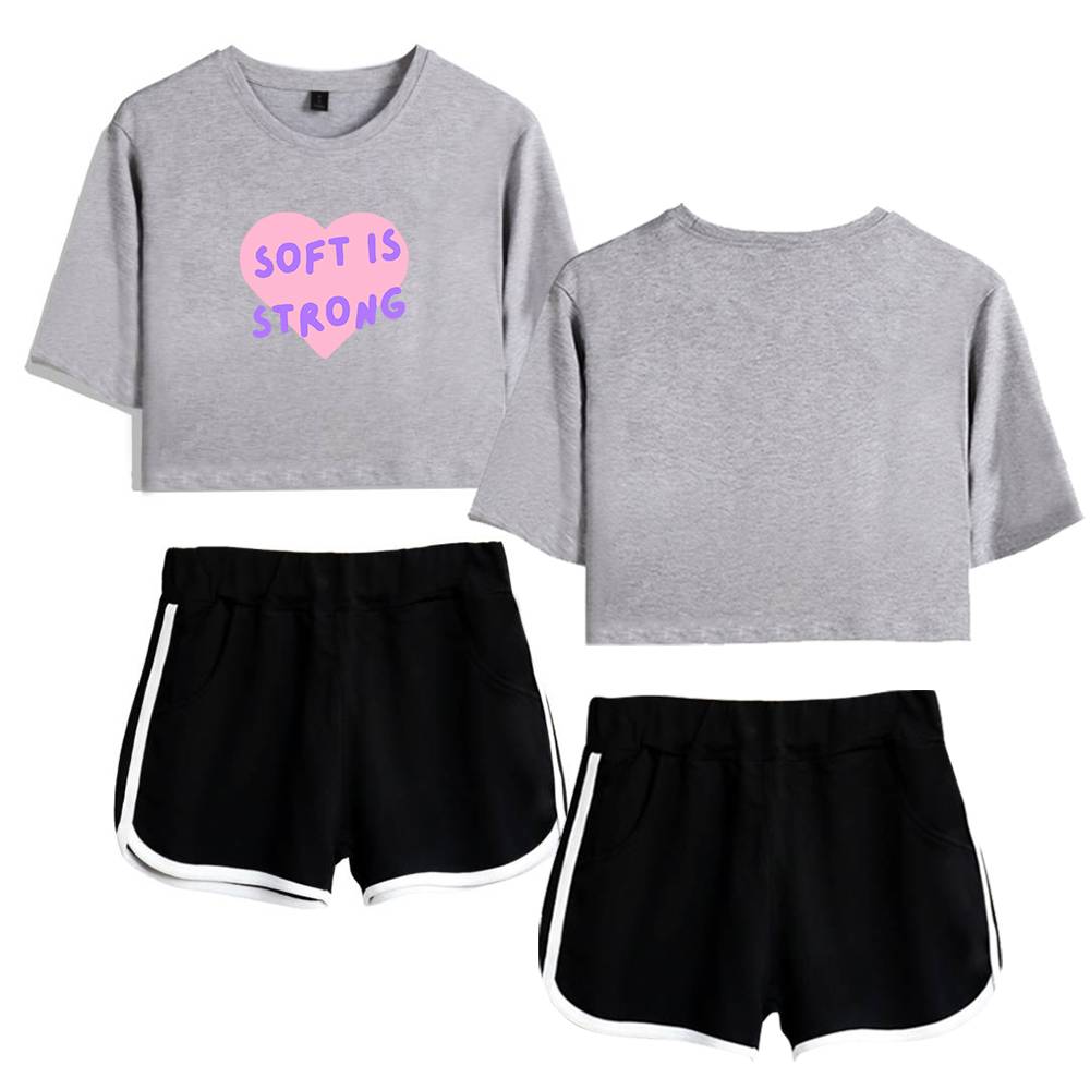 Comfy gray cropped sweatshirt with pink and purple "Soft is Strong" graphic, paired with black athletic shorts with white trim, perfect Justin Bieber swag merch style for casual streetwear.