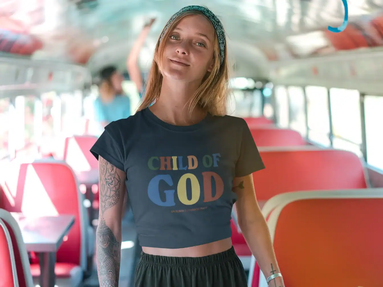 Confident woman wearing Justin Bieber swag merch on a bus interior stylish streetwear fashion.